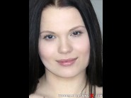 Ella martin is sited on a sofa, legs appart and looking at you