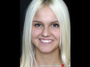 Joleyn burst is sited on a sofa, legs appart and looking at you