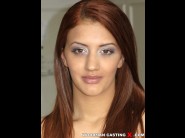 Aylin diamond is sited on a sofa, legs appart and looking at you