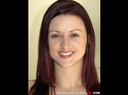 Karlie montana is sited on a sofa, legs appart and looking at you