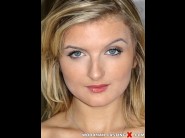 Jemma valentine is sited on a sofa, legs appart and looking at you