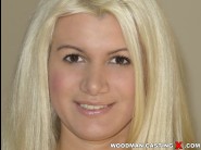 Layla price is sited on a sofa, legs appart and looking at you