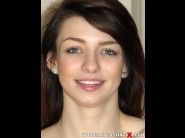 Aspen ora is sited on a sofa, legs appart and looking at you