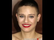 Electre is sited on a sofa, legs appart and looking at you