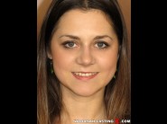 Vlasta is sited on a sofa, legs appart and looking at you