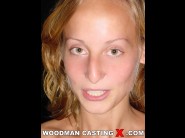 Dike is sited on a sofa, legs appart and looking at you