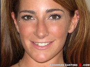 Savannah fox is sited on a sofa, legs appart and looking at you