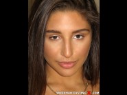 Abella danger is sited on a sofa, legs appart and looking at you