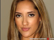 Chloe amour is sited on a sofa, legs appart and looking at you