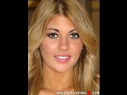 Kayla kayden is sited on a sofa, legs appart and looking at you