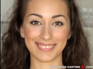 Leyla bentho is sited on a sofa, legs appart and looking at you