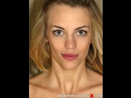 Blacke eden is sited on a sofa, legs appart and looking at you