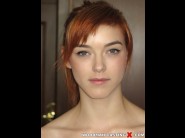 Anny aurora is sited on a sofa, legs appart and looking at you