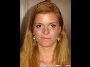 Chrissy fox is sited on a sofa, legs appart and looking at you