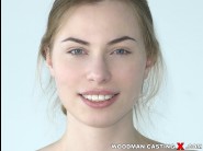 Milena devi is sited on a sofa, legs appart and looking at you