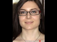 Elisa ken is sited on a sofa, legs appart and looking at you