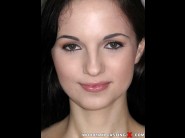 Kristy black is sited on a sofa, legs appart and looking at you