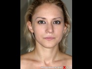 Suzan is sited on a sofa, legs appart and looking at you