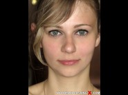 Angela terra is sited on a sofa, legs appart and looking at you