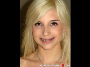 Piper perri is sited on a sofa, legs appart and looking at you