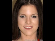 Jenna jay is sited on a sofa, legs appart and looking at you