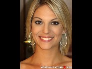 Alix feeling is sited on a sofa, legs appart and looking at you