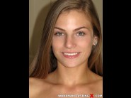 Sydney cole is sited on a sofa, legs appart and looking at you