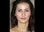 Nikole barher is sited on a sofa, legs appart and looking at you