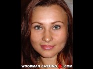 Natalia dinov is sited on a sofa, legs appart and looking at you