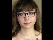 Fira ventura is sited on a sofa, legs appart and looking at you