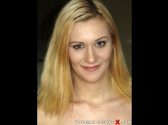 Pamela stanwick is sited on a sofa, legs appart and looking at you