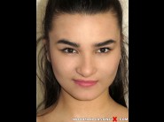 Ester lamy is sited on a sofa, legs appart and looking at you