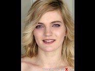 Carly rae is sited on a sofa, legs appart and looking at you