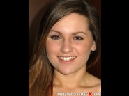 Valerie fox is sited on a sofa, legs appart and looking at you