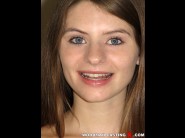 Alice march is sited on a sofa, legs appart and looking at you