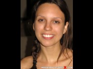 Jade nile is sited on a sofa, legs appart and looking at you