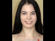 Lovenia lux is sited on a sofa, legs appart and looking at you