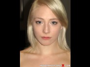 Trillium is sited on a sofa, legs appart and looking at you