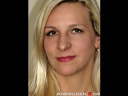 Bianca ferrero is sited on a sofa, legs appart and looking at you