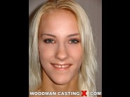 Justine ashley is sited on a sofa, legs appart and looking at you