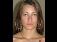 Kirsten lee is sited on a sofa, legs appart and looking at you