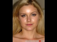 Marley matthews is sited on a sofa, legs appart and looking at you