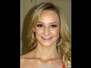 Emma hix is sited on a sofa, legs appart and looking at you