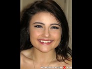 Adria rae is sited on a sofa, legs appart and looking at you