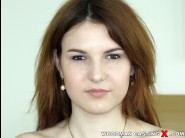 Allegra is sited on a sofa, legs appart and looking at you