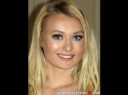 Natalia starr is sited on a sofa, legs appart and looking at you