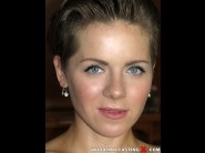 Sasha zima is sited on a sofa, legs appart and looking at you