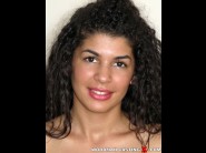 Laurita rios is sited on a sofa, legs appart and looking at you