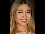 Nyomi star is sited on a sofa, legs appart and looking at you