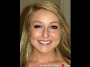 White valerie is sited on a sofa, legs appart and looking at you